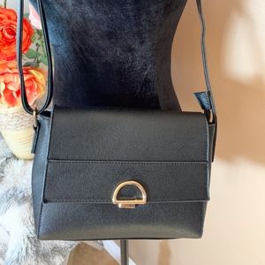 Black crossbody purse with golden hardware.